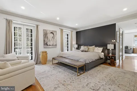 a bedroom with a bed and glass wall