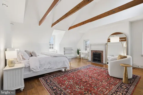 a spacious bedroom with a bed and a window