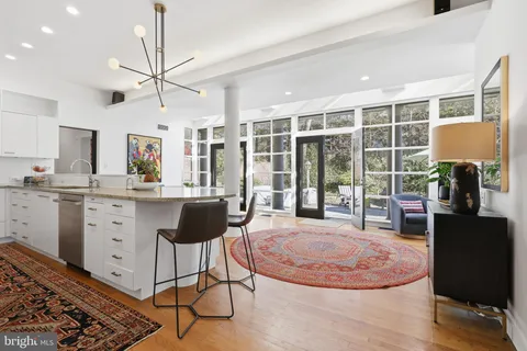 a view of a livingroom with furniture and a kitchen