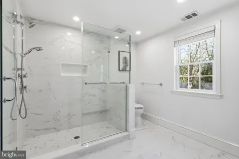 a bathroom with a granite countertop sink mirror and bathtub