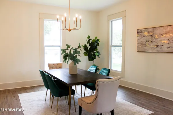 a dining room with furniture and wooden floor