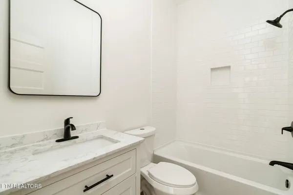 a bathroom with a sink a toilet and a bathtub
