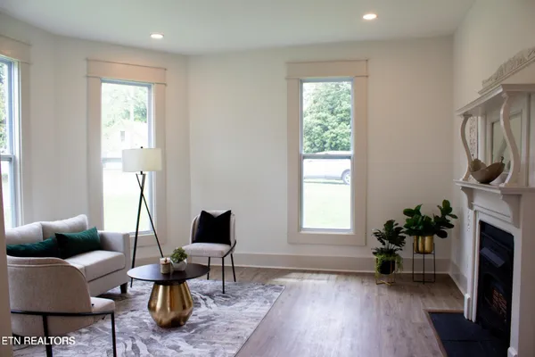 a living room with furniture and a fireplace