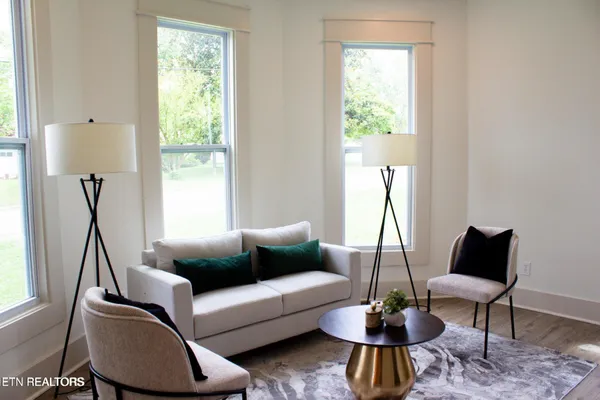 a living room with furniture and a large window
