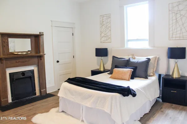 a bedroom with a bed and a fireplace