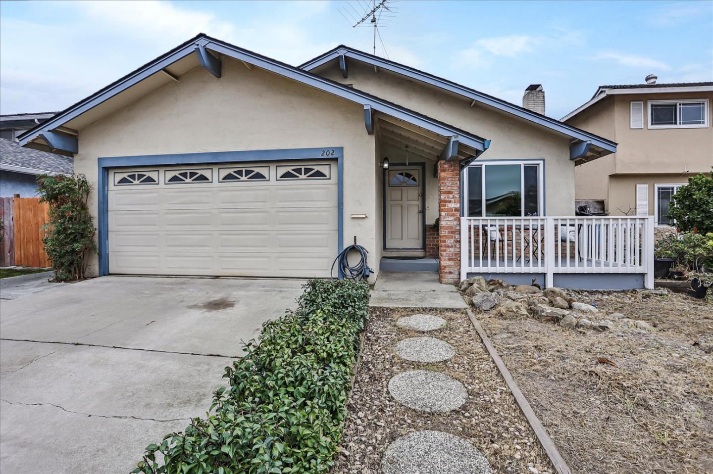 a front view of a house with garden
