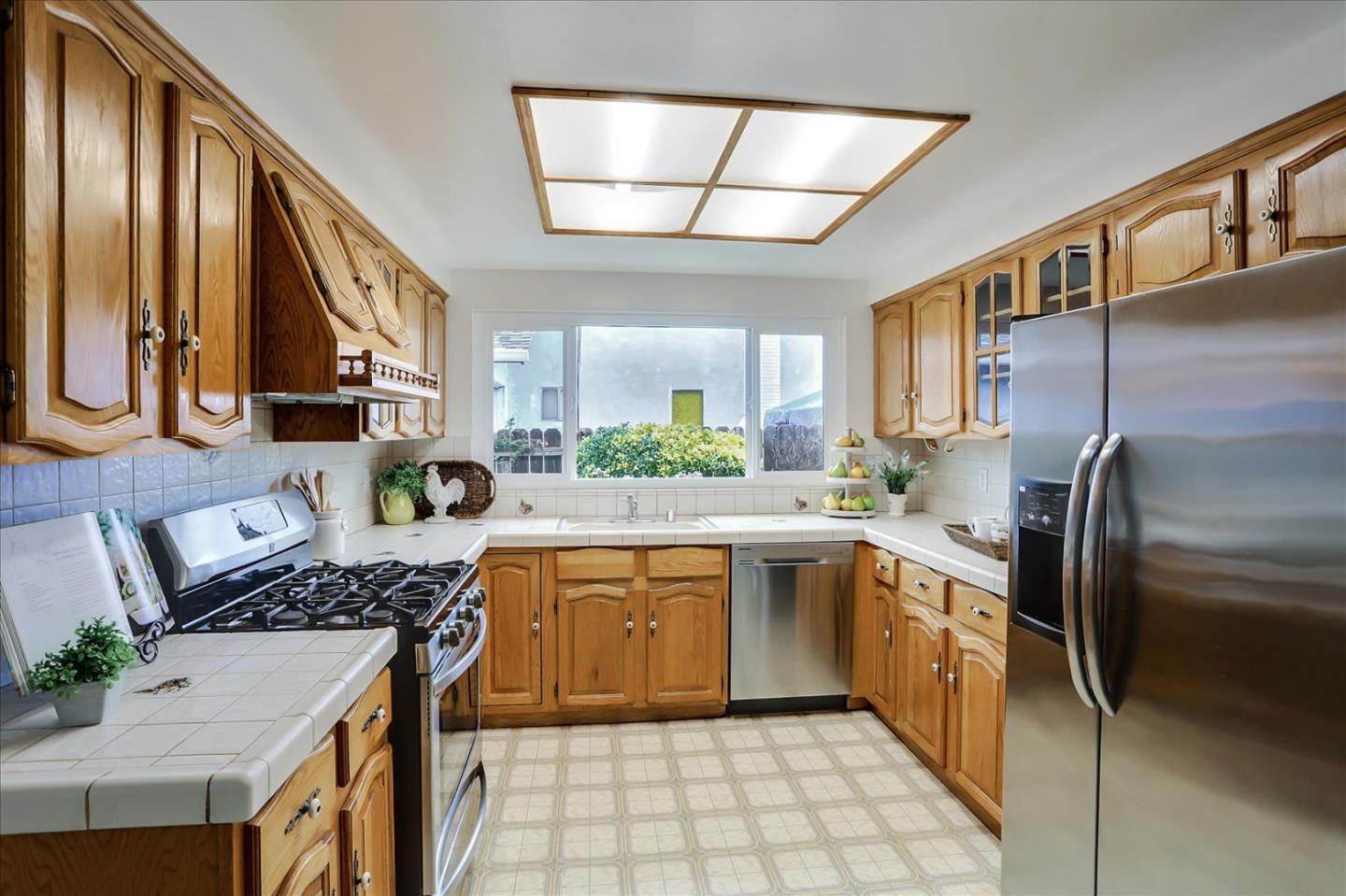 202 Greentree Way Milpitas, CA 95035 - Photo 11 of 28 a kitchen with stainless steel appliances granite countertop a stove a sink dishwasher and a refrigerator