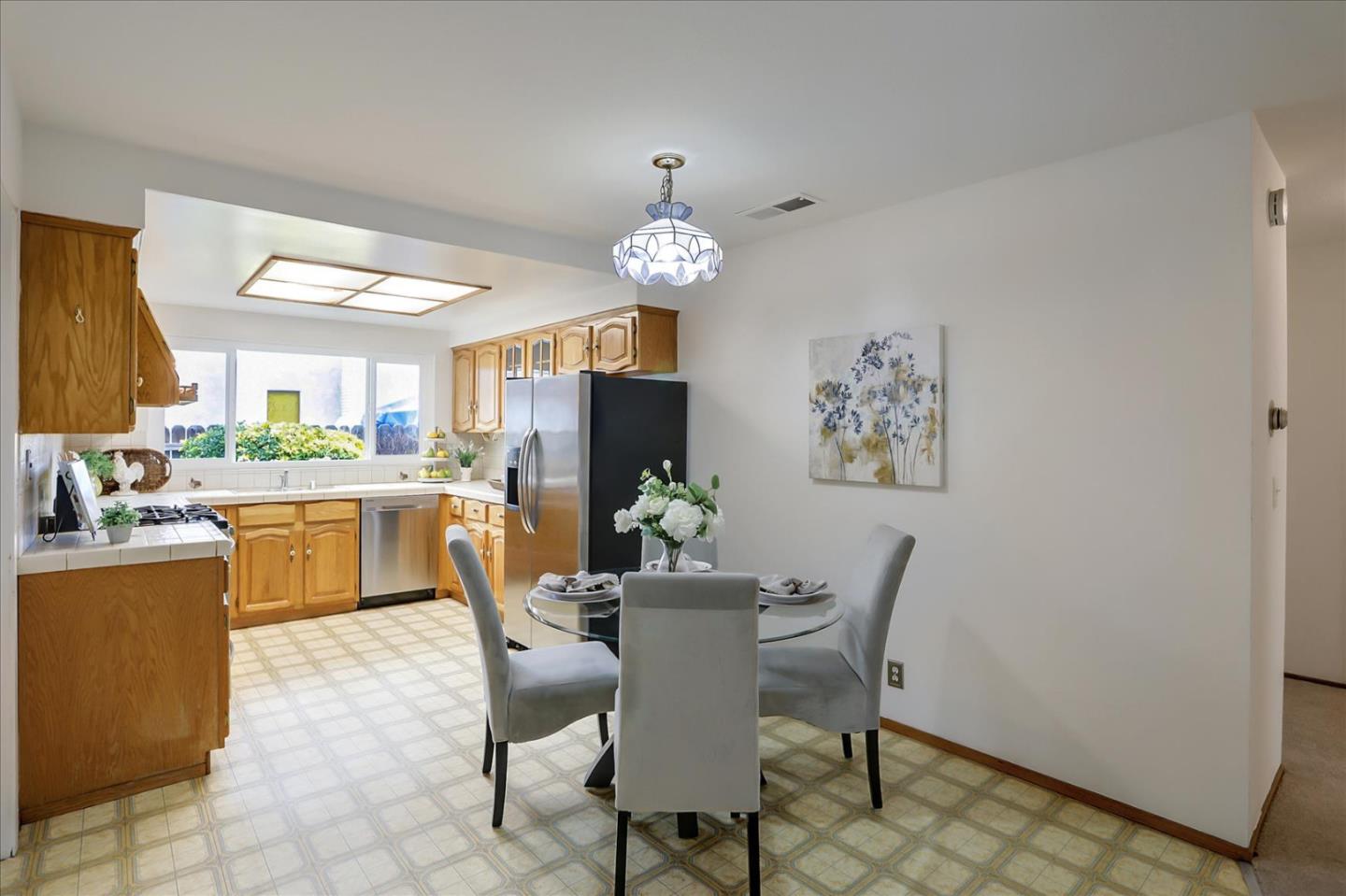 202 Greentree Way Milpitas, CA 95035 - Photo 14 of 28 a dining room with furniture a window and a chandelier