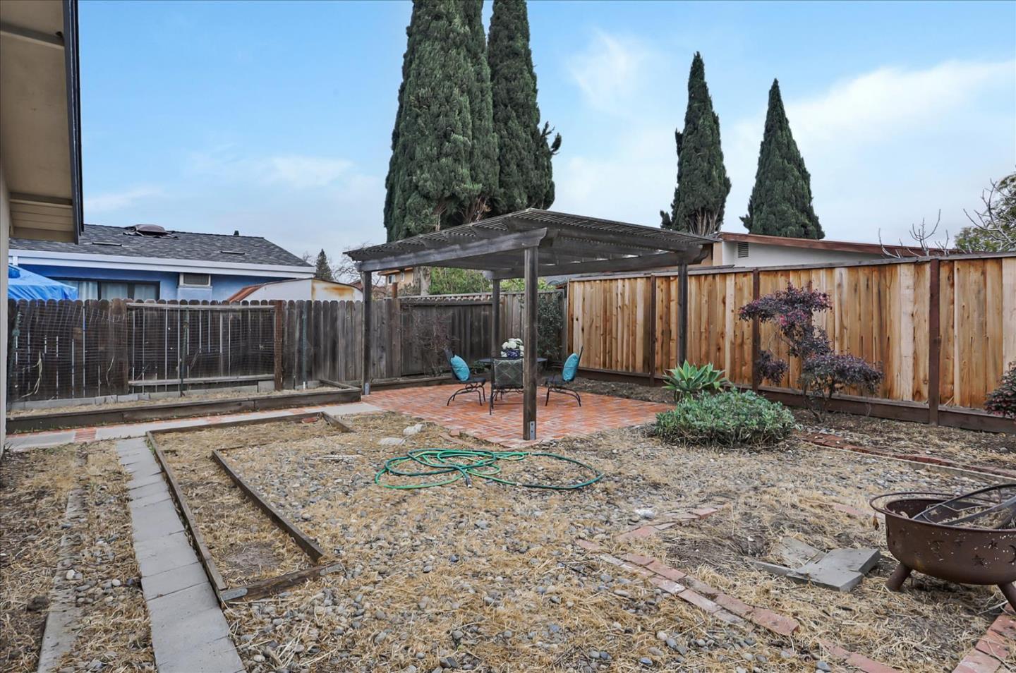 202 Greentree Way Milpitas, CA 95035 - Photo 27 of 28 a backyard of a house with barbeque oven and outdoor seating