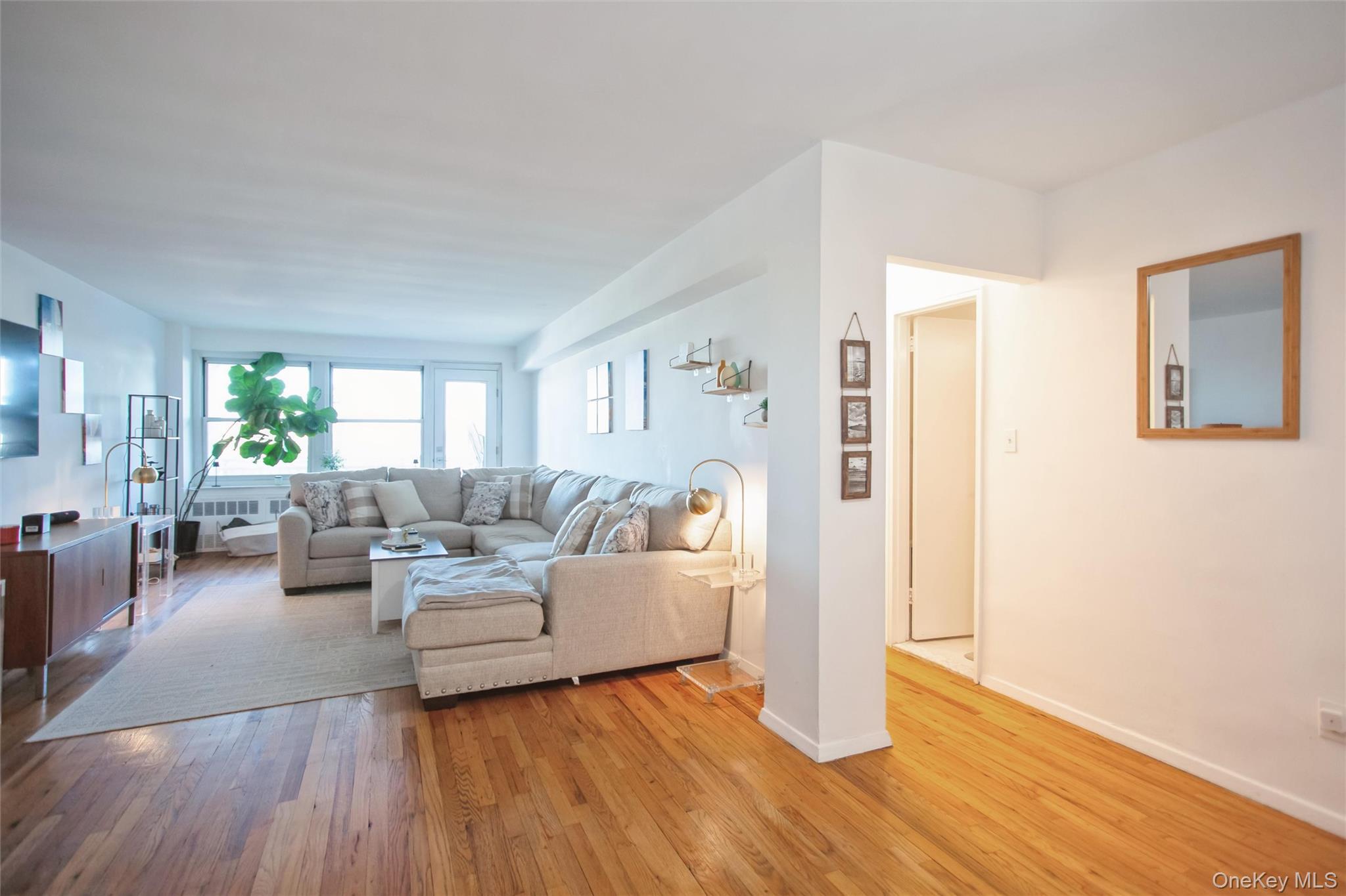 711 Shore Road, Unit 2C Long Beach, NY 11561 - Photo 7 of 27 a living room with fireplace furniture and a wooden floor