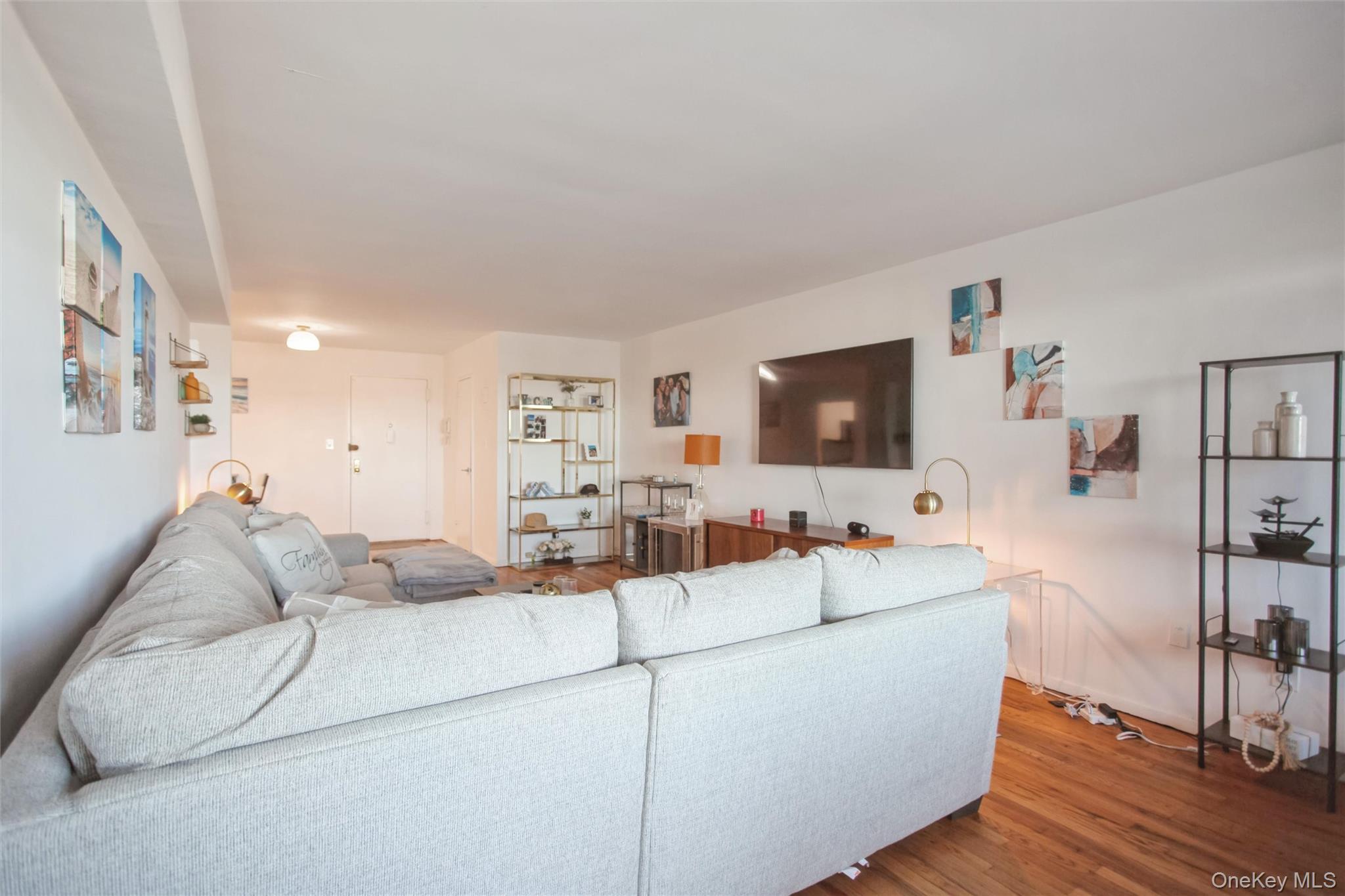 711 Shore Road, Unit 2C Long Beach, NY 11561 - Photo 9 of 27 a living room with furniture and a flat screen tv