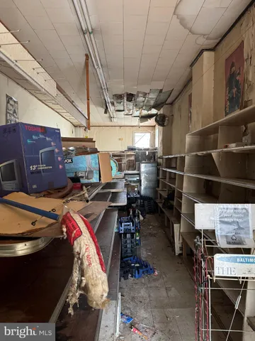 a view of a livingroom with furniture hardwood and a window