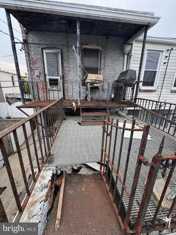 a view of a brick house with a small yard