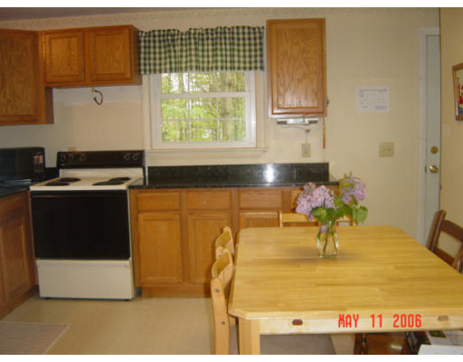 0 Rita Hudson, NH 03051 - Photo 3 of 9 a kitchen with stainless steel appliances granite countertop a sink and a stove