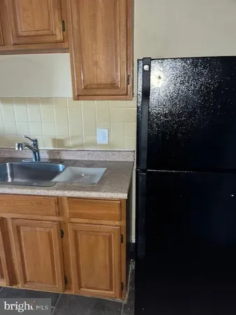 a kitchen with a refrigerator and cabinets
