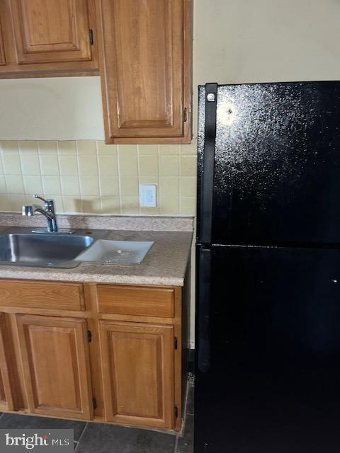 a kitchen with a refrigerator and cabinets