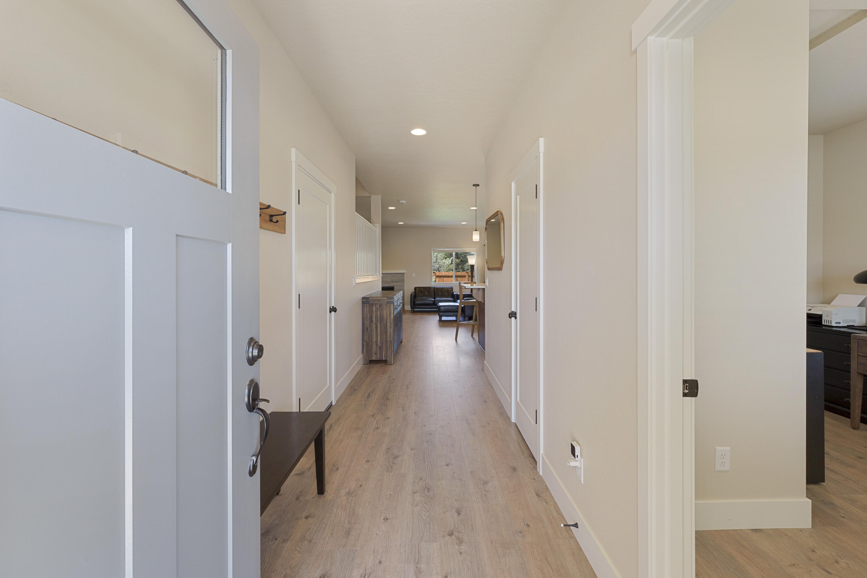 4999 Southwest Yew Place Redmond, OR 97756 - Photo 6 of 50 a view of a hallway with wooden floor and a bathroom
