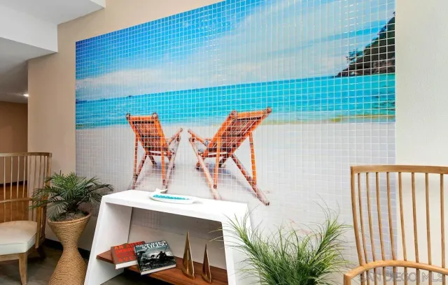 a view of a patio with couches and a potted plant on the road