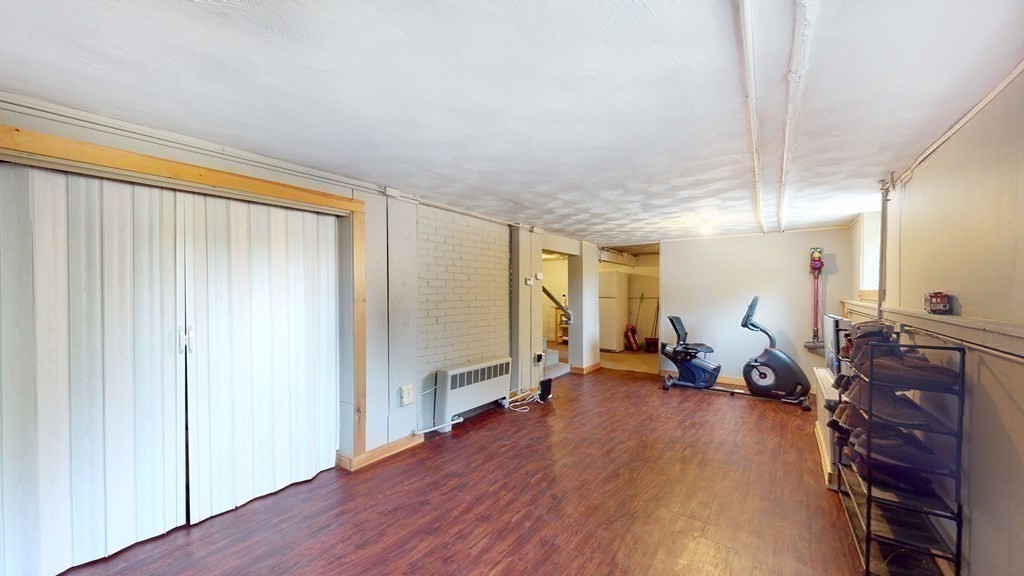 12 James Street Winchester, MA 01890 - Photo 17 of 23 a living room with furniture a wooden floor and a large window