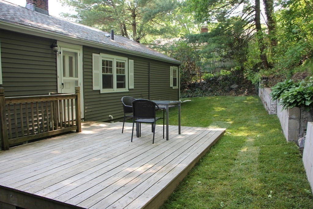 12 James Street Winchester, MA 01890 - Photo 21 of 23 a view of a deck with a table and chairs and potted plants