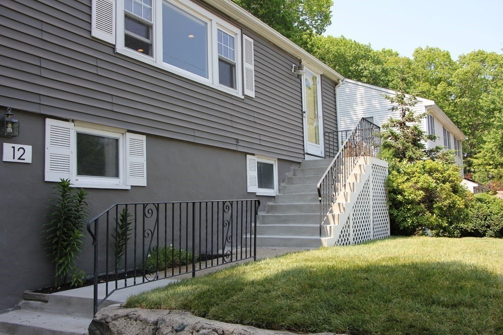 12 James Street Winchester, MA 01890 - Photo 3 of 23 a front view of a house with a yard