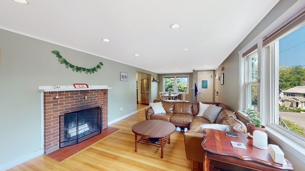 12 James Street Winchester, MA 01890 - Photo 7 of 23 a living room with furniture a fireplace and a large window