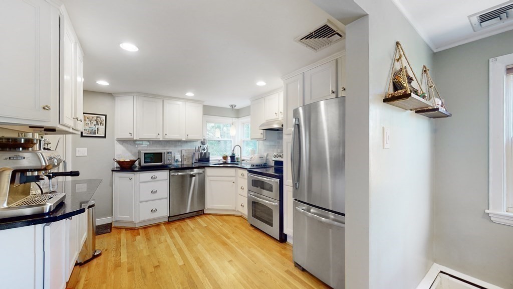 12 James Street Winchester, MA 01890 - Photo 8 of 23 a kitchen with a refrigerator a sink and cabinets
