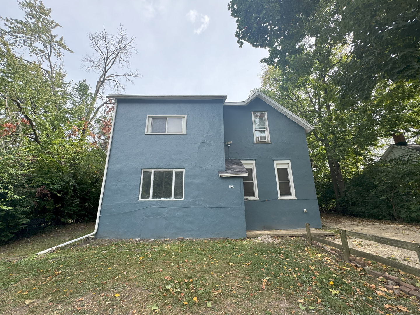 202 South Grove Street Urbana, IL 61802 - Photo 1 of 8 a red brick house with trees in front of it