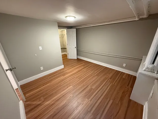 a view of a room with wooden floor