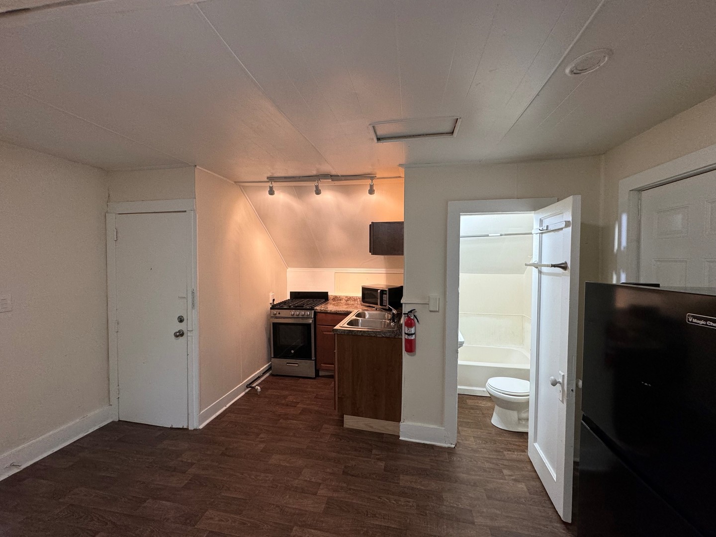 202 South Grove Street Urbana, IL 61802 - Photo 6 of 8 a view of a kitchen with refrigerator and wooden floor