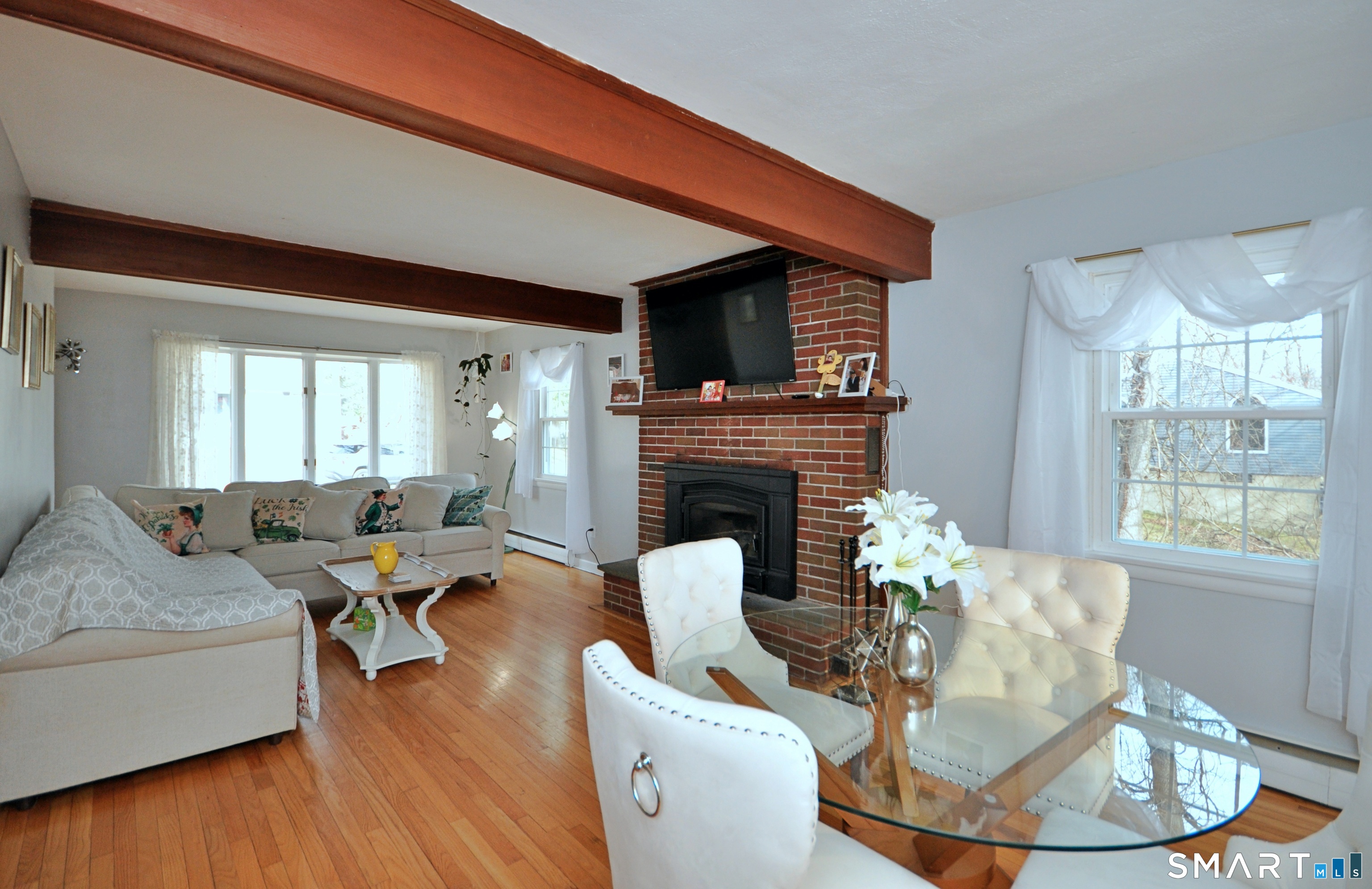 21 Maple Drive Prospect, CT 06712 - Photo 10 of 29 a living room with furniture a fireplace and a large window