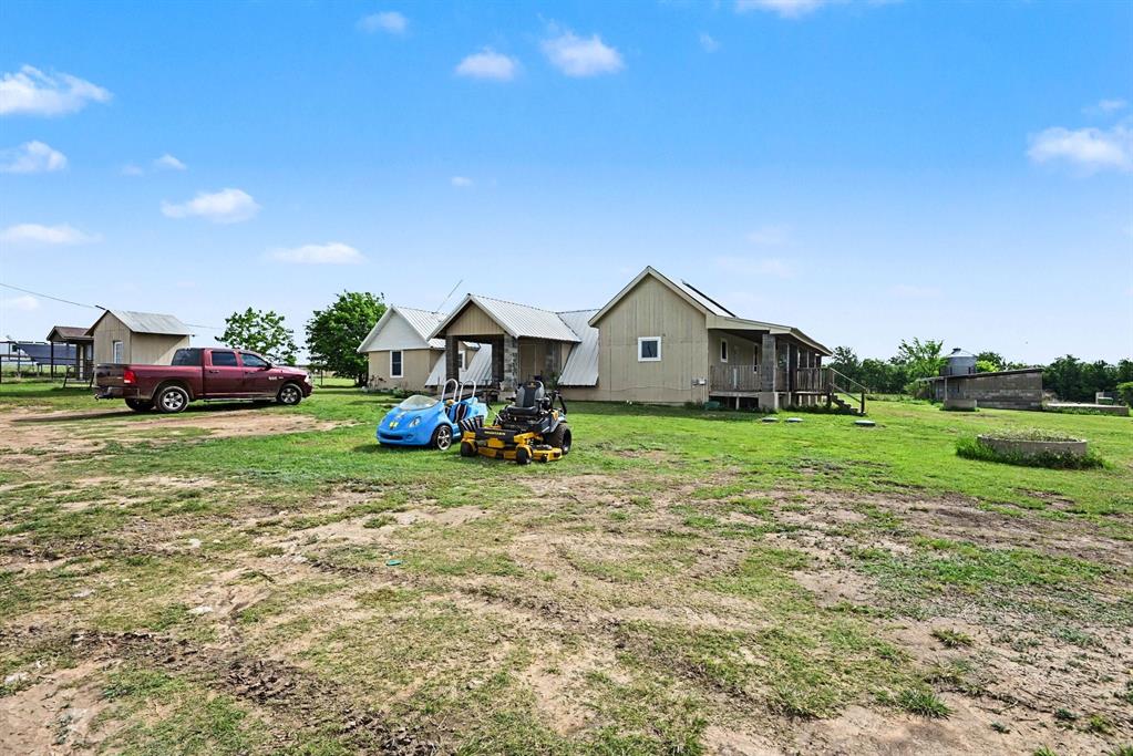 6694 Hutcheson Hill Road Springtown, TX 76082 - Photo 3 of 37 a front view of a house with garden