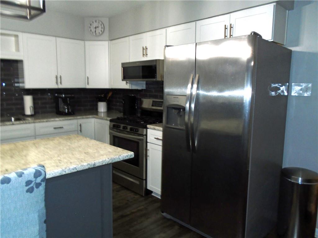 480 Heller Street Rochester, PA 15074 - Photo 10 of 31 a kitchen with kitchen island a counter top space cabinets and stainless steel appliances