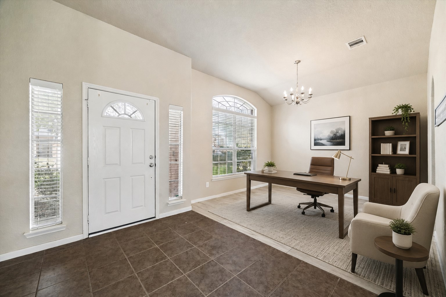 7806 Summer Night Lane Rosenberg, TX 77469 - Photo 5 of 23 Home office near the entry with a chandelier and large arched window for natural light, featuring tile flooring at the foyer that transitions to wood-look flooring to the home office. **This room has been virtually staged.