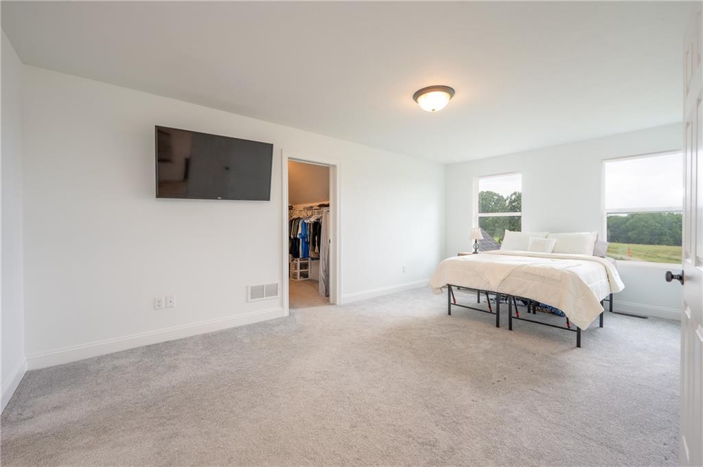356 Stone Church Road Hunker, PA 15639 - Photo 17 of 40 a spacious bedroom with a bed and a television