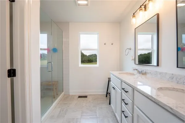 a bathroom with a granite countertop sink mirror and double