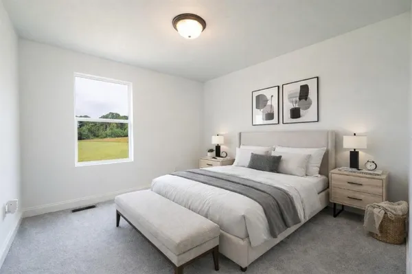 a bedroom with bed and a window