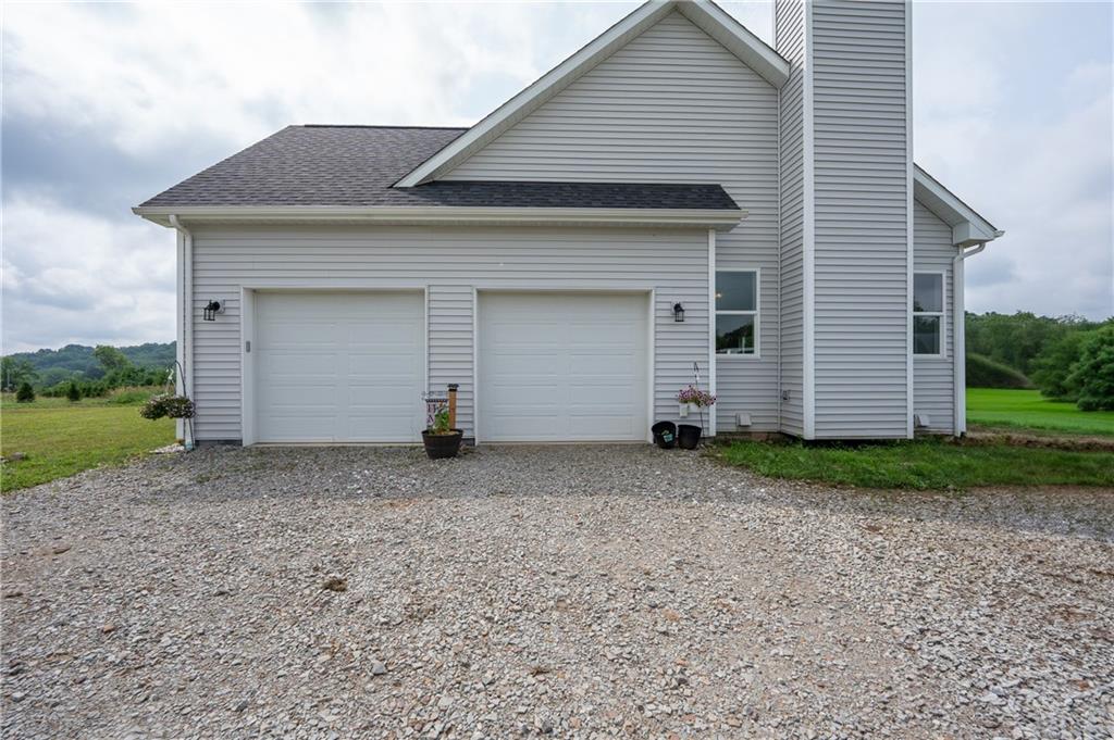356 Stone Church Road Hunker, PA 15639 - Photo 38 of 40 a backyard of a house with garage and garage