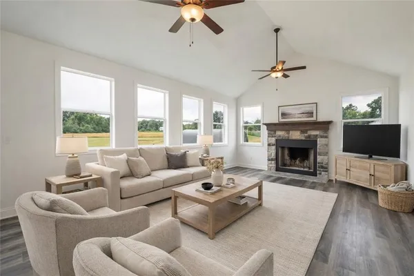 a living room with furniture a fireplace and a flat screen tv