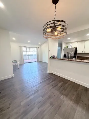 a view of a kitchen with a dishwasher and wooden floor