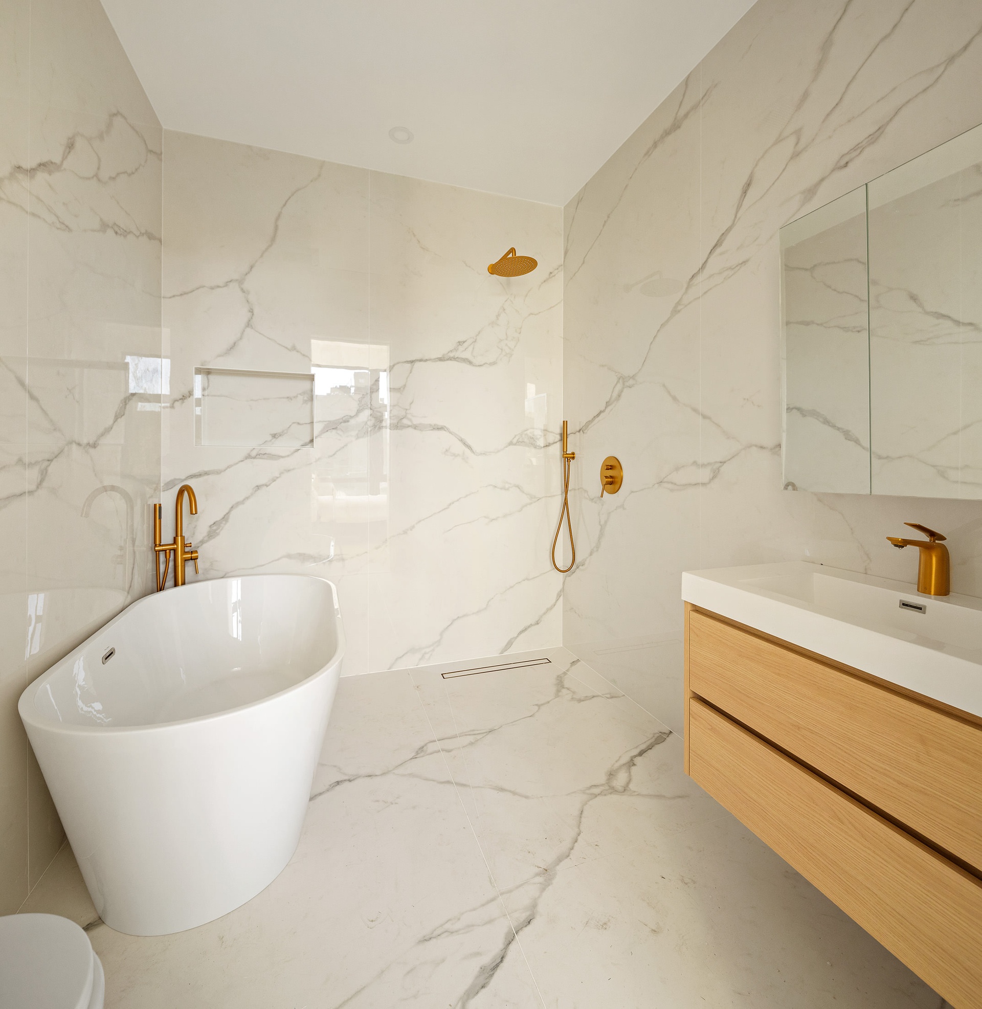 1027 Bushwick Avenue, Unit 2D Brooklyn, NY 11221 - Photo 8 of 14 a white bath tub sitting next to a white sink and vanity
