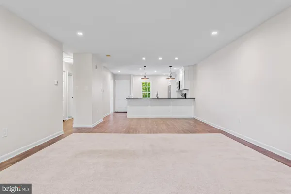 a view of a kitchen with a sink and a refrigerator