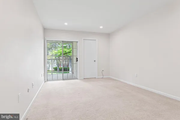 an empty room with large windows