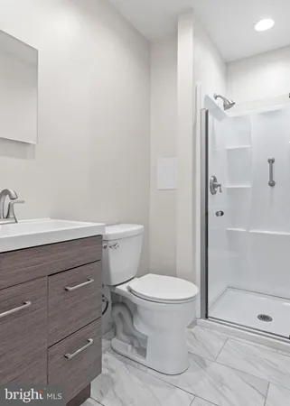 a bathroom with a toilet and a shower