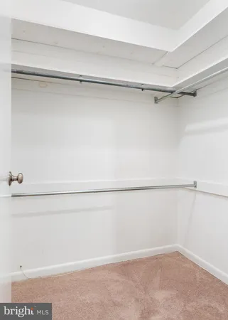 a view of a closet with wooden floor