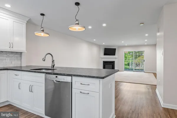 a kitchen with a sink window and cabinets