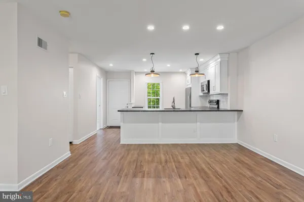 a view of kitchen with wooden floor and window