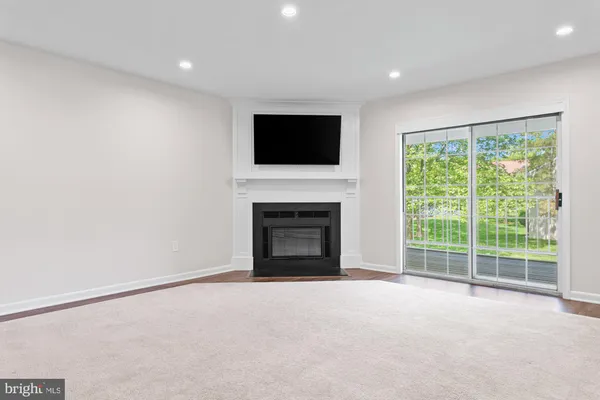 a view of empty room with a fireplace