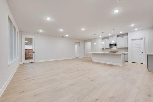 a view of kitchen with kitchen island and stainless steel appliances