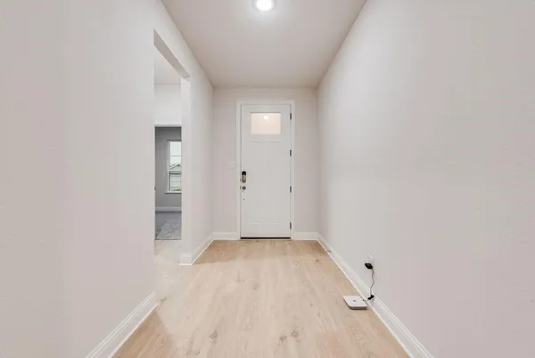 a view of a hallway with wooden floor